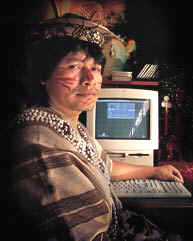 Photograph of Mino in front of his computer